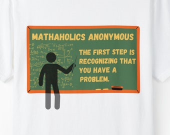 May include: White t-shirt with a green chalkboard design. The text reads "MATHAHOLICS ANONYMOUS" and "THE FIRST STEP IS RECOGNIZING THAT YOU HAVE A PROBLEM." A stick figure points to the text on the board.
