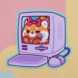 May include: A sticker featuring a cartoon red panda inside a vintage computer monitor. The red panda has a pink bow and is surrounded by a light blue border. The computer is purple with a matching mouse and keyboard. The background is a mix of pink and yellow.