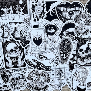 May include: A set of black and white stickers featuring various gothic and occult imagery, including skulls, hearts, eyes, and a coffin. The stickers are perfect for adding a touch of darkness to laptops, water bottles, or journals.