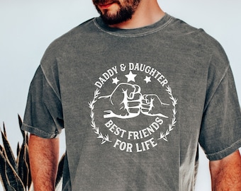 May include: A gray t-shirt with a white graphic that says "Daddy & Daughter Best Friends For Life" with a fist bump design.