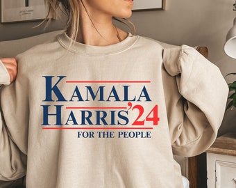 May include: A beige sweatshirt with the text "Kamala Harris '24 For The People" printed in blue and red.