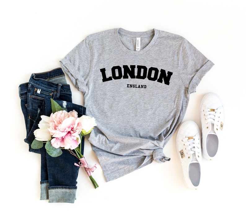 May include: A gray t-shirt with the text "LONDON ENGLAND" in black block letters.