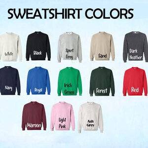 May include: A chart showing 15 different sweatshirt colors. The colors are: White, Black, Sport Grey, Sand, Dark Heather, Navy, Royal, Irish Green, Forest, Red, Maroon, Light Pink, Ash Grey.