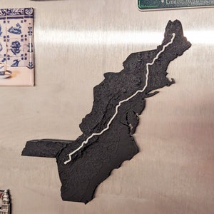May include: A black map of the northeastern United States with a white line tracing the Appalachian Trail.