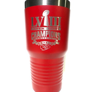 May include: Red insulated tumbler with a silver lid. The tumbler features the text "LVIII Super Bowl Champions Kansas City Chiefs" in silver lettering, along with the Super Bowl trophy and the Chiefs logo.