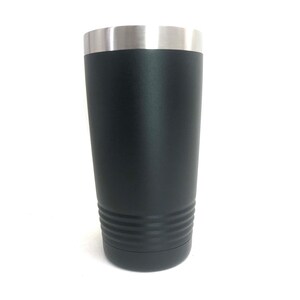 May include: A black stainless steel tumbler with a silver lid. The tumbler has a textured bottom and a smooth, matte finish.
