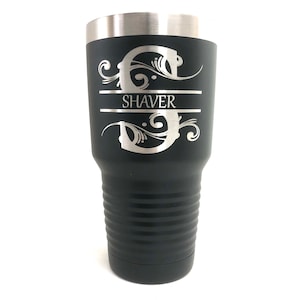 May include: Black stainless steel tumbler with a silver engraved monogram and the name "SHAVER".
