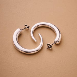 Silver crescent hoop earrings, sculptural bold silver hoops