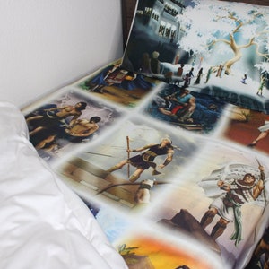 May include: A white twin-sized bed with a colourful bedspread featuring various scenes of people and landscapes. The bedspread has a patchwork design with each scene framed in a square. The bedspread is made of a soft, comfortable fabric.