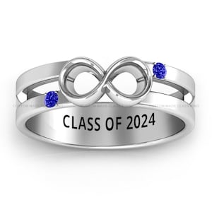 May include: Silver infinity ring with two blue gemstones and the inscription "CLASS OF 2024".