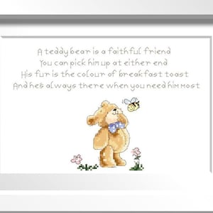 May include: Framed artwork featuring a cross-stitched teddy bear with a blue bow tie, a bee, and flowers. The text reads, "A teddy bear is a faithful friend..." in a whimsical font. The frame is white.