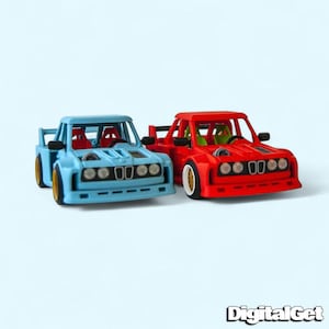 May include: Two toy cars, one light blue and one red, are displayed against a light blue background. The cars have a sporty design with spoilers and racing seats. The front of each car has a series of circular lights. The text "DigitalGet" is in the bottom right corner.