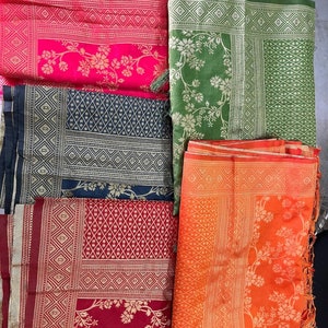 May include: Five different patterned scarves in various colors, including pink, green, black, red, and orange. Each scarf has a gold border and a floral design.