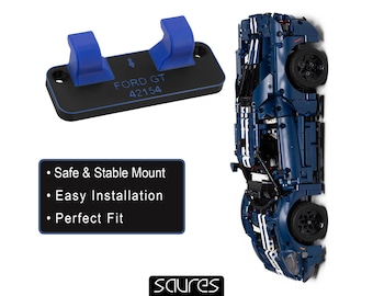 May include: A blue and black mounting bracket with the text "FORD GT 42154" and a blue model car. The bracket has two blue supports. A black box lists "Safe & Stable Mount", "Easy Installation", and "Perfect Fit".