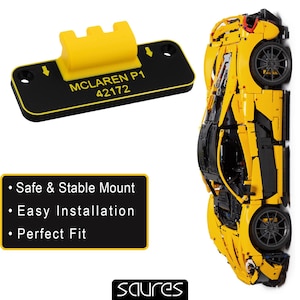 May include: A yellow and black McLaren P1 model car next to a black mount with the text "MCLAREN P1 42172". The mount has a yellow bracket. Text on the mount reads "Safe & Stable Mount", "Easy Installation", and "Perfect Fit".