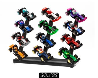 May include: A display of colorful toy race cars in various colors, including red, green, blue, and orange. Each car is mounted on a black stand. The logo "saures" is at the bottom.
