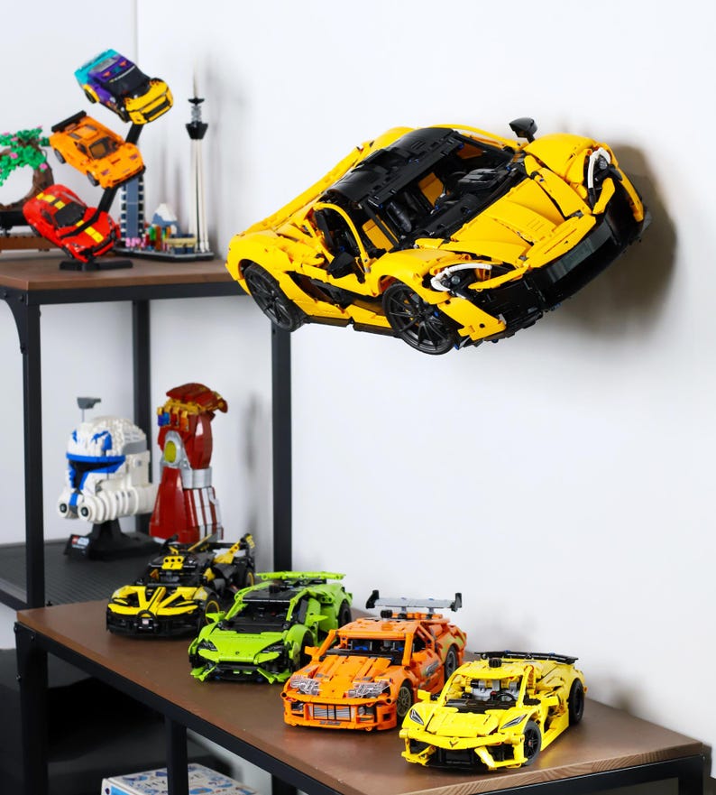 May include: A collection of yellow, orange, green, and black toy cars. The cars are made of plastic and have a variety of designs. The cars are displayed on a shelf with a white background.