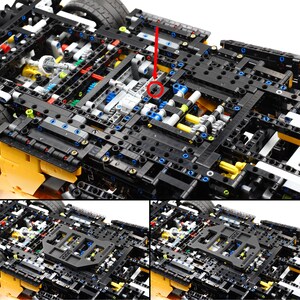 May include: Close-up view of a complex Lego Technic model with intricate gears and mechanisms. The model is built with black, yellow, blue, and gray Lego bricks. The model is partially disassembled, revealing the inner workings of the vehicle.