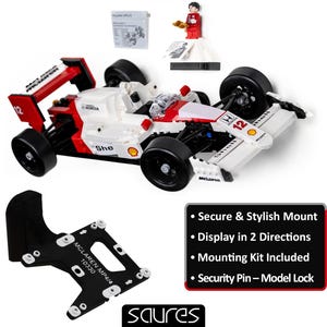 May include: A white, red, and black McLaren MP4/4 race car model with the number 12. Includes a black mounting bracket, a small figurine, and a sign with text: "Secure & Stylish Mount".