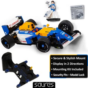 May include: A blue, white, and yellow Williams Renault FW14B race car model with black wheels. Includes a mounting kit, a small figurine, and a black mounting bracket. The text on the car includes "Canon", "elf", and "Goodyear".