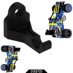 May include: A black 3D printed wall mount for a toy car. The mount has a hole in the top for hanging. The mount is designed to hold a toy car in a vertical position.