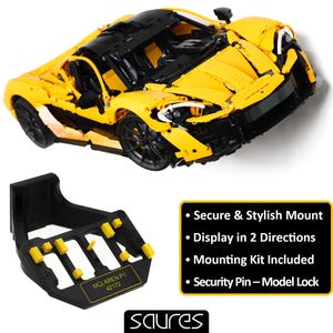 May include: A yellow and black Lego McLaren P1 model car with a black display stand. The stand has a black base with yellow tabs and the text "McLaren P1 42172".