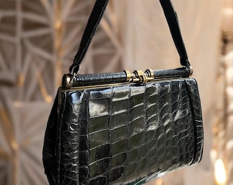 Vintage Art Deco bag, circa 1920-1940, made of black leather with a stylized brass clasp. Antique handbag, Great Gatsby, Roaring Twenties