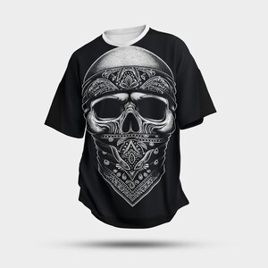 May include: Black t-shirt featuring a white skull graphic wearing a bandana. The skull has a detailed design with paisley patterns.
