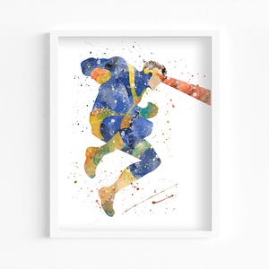 May include: Watercolor painting of a superhero in a dynamic pose, framed in white. The figure is depicted in blue and yellow, with a red beam emanating from the eyes. Splatter effects add to the artwork's vibrant, action-packed feel.