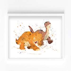 May include: A framed watercolor-style art print featuring two dinosaurs in motion. One is a textured orange triceratops in the foreground, and the other is a smaller, brown long-necked dinosaur behind it, both surrounded by colorful paint splatters.