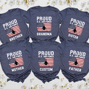 May include: Six navy blue t-shirts with the text "Proud U.S. Air Force" and an American flag with a jet plane graphic. The shirts have the words "Brother", "Grandma", "Sister", "Mother", "Custom", and "Father" printed on them.