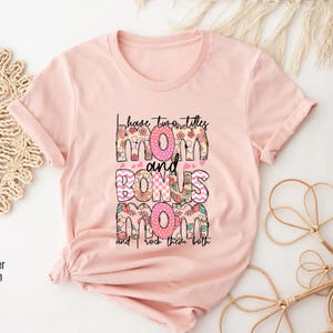 a pink t - shirt with the words mom and boss printed on it