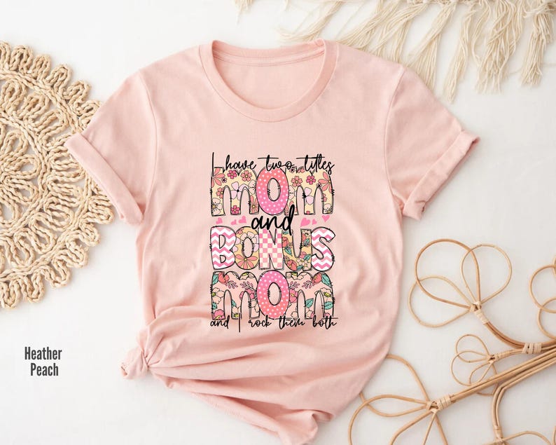 a pink t - shirt with the words mom and boss printed on it