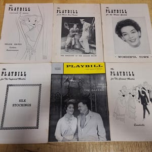 May include: A collection of vintage Playbill theater programs. The covers feature illustrations and photographs from various productions, including "Wonderful Town," "Silk Stockings," and "The Gazebo." The programs are printed in black and white.