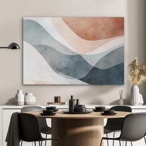 May include: Abstract wall art featuring flowing, layered shapes in shades of blue, gray, white, and terracotta. The artwork is displayed above a dining table set with black plates and chairs, creating a modern aesthetic.