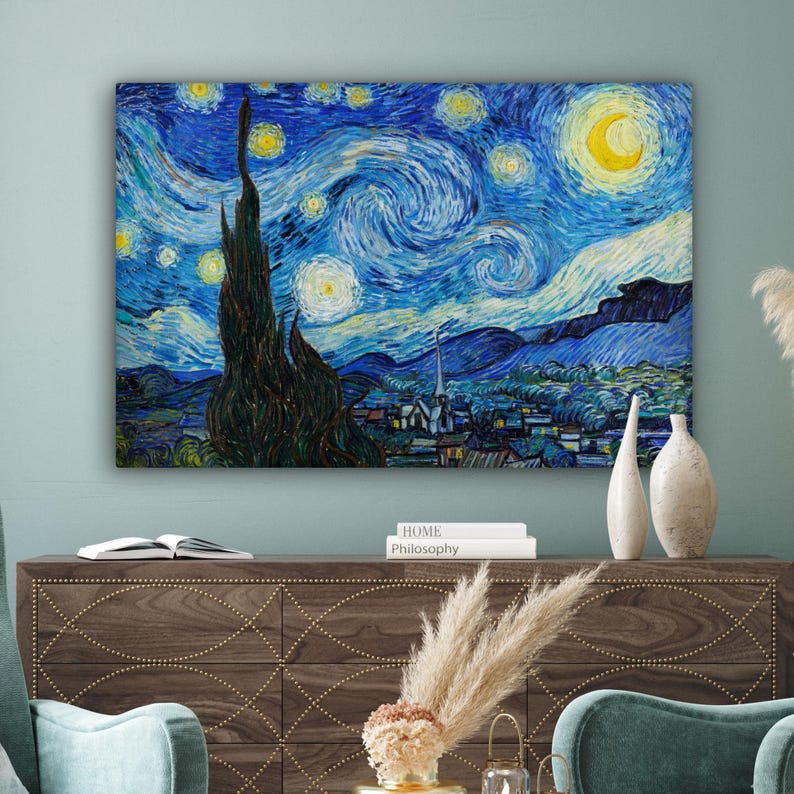 May include: A canvas print of Vincent van Gogh's "The Starry Night" painting. The artwork features a swirling blue night sky with yellow stars and a crescent moon. A dark, tall cypress tree is in the foreground, with a village below.