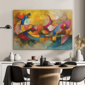 Könnte beinhalten: Abstrakte Leinwandkunst mit einer lebendigen Mischung aus Farben wie Gelb, Rot, Blau und Rosa. Das Kunstwerk zeigt geometrische Formen und geschwungene Linien, die eine dynamische Komposition erzeugen. Das Gemälde hängt über einem Esstisch.