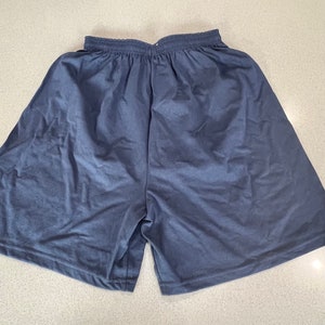May include: A pair of dark blue athletic shorts with an elastic waistband.