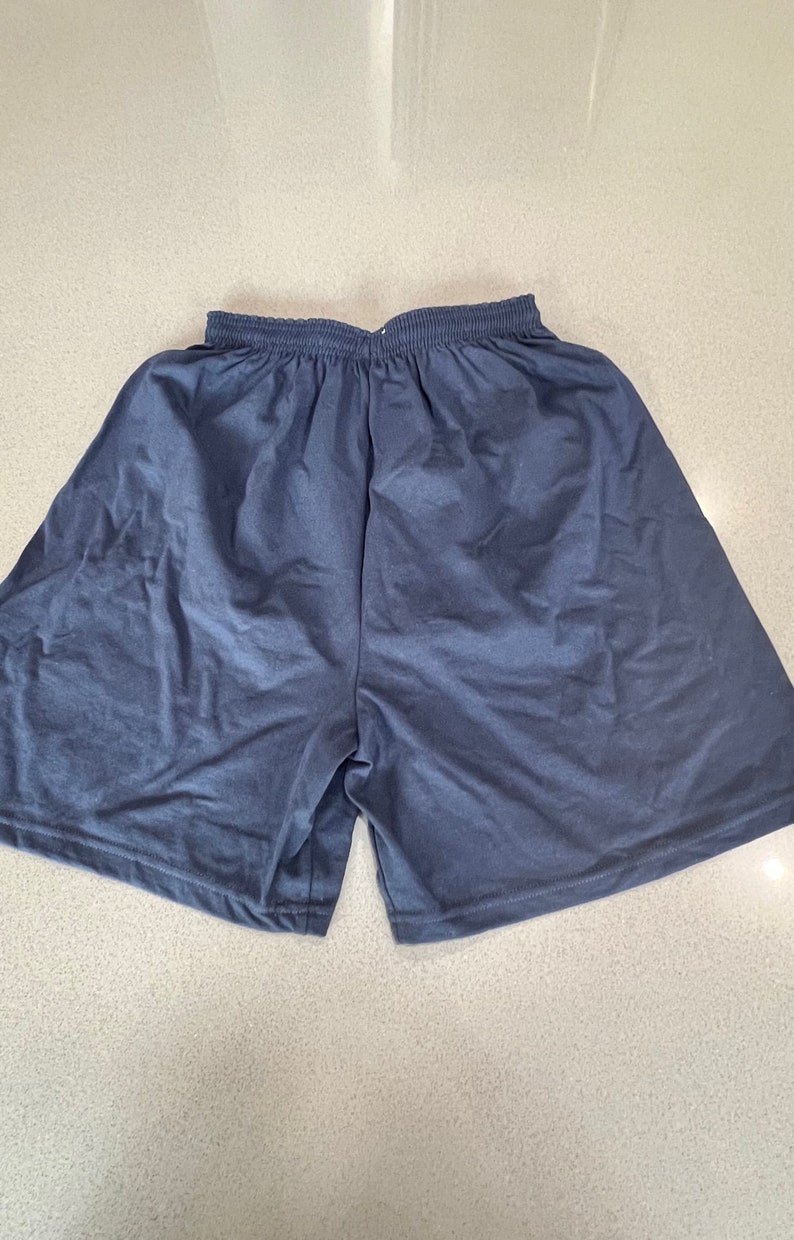 May include: A pair of dark blue athletic shorts with an elastic waistband.