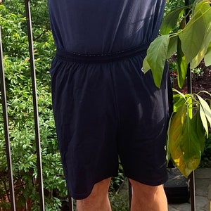 May include: A pair of dark blue athletic shorts with a drawstring waistband.