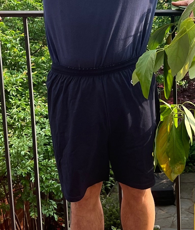 May include: A pair of dark blue athletic shorts with a drawstring waistband.