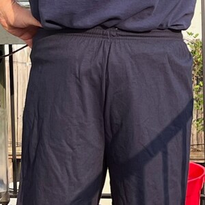 May include: A pair of dark blue athletic shorts with an elastic waistband.