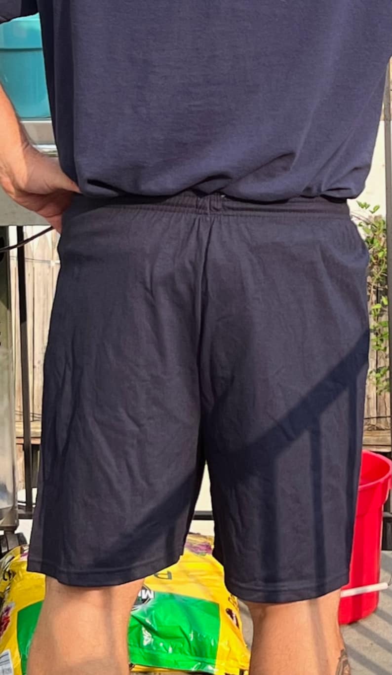 May include: A pair of dark blue athletic shorts with an elastic waistband.