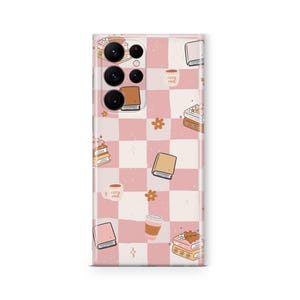 May include: A phone case with a pink and white checkered pattern. The case is decorated with illustrations of books, coffee cups, flowers, and the text "cozy vibes". The case is designed to fit a smartphone.