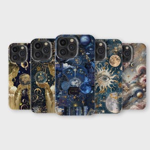May include: A selection of phone cases with celestial designs. Each case features a unique illustration with moons, stars, suns, and other cosmic elements in shades of blue, gold, and cream. The cases are arranged in a row, showcasing the variety of artwork.