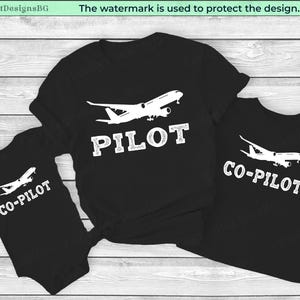 May include: Black t-shirts and a baby onesie with white airplane graphics. The adult shirt says "PILOT", the other shirt and onesie say "CO-PILOT". The design includes a white airplane graphic above the text.