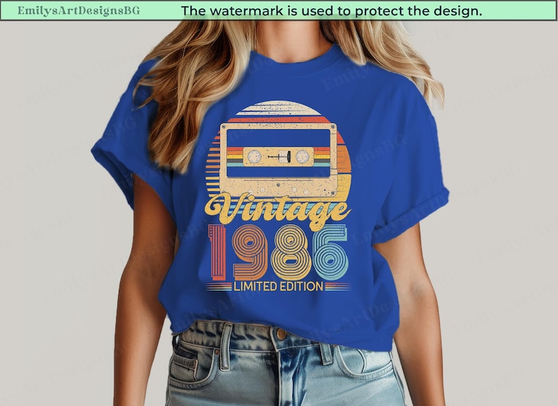 May include: Blue t-shirt featuring a retro design with a cassette tape graphic, a sunset, and the text "Vintage 1985 Limited Edition." The design incorporates orange, yellow, red, and blue colors.