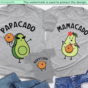 May include: Three grey t-shirts with avocado and orange illustrations. The shirts have the text "PAPACADO", "MAMACADO", and "BABYCADO" on them.