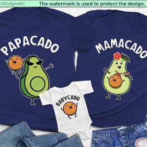 May include: Three navy blue t-shirts with avocado and peach illustrations. The shirts have the text "PapaCado", "MamaCado", and "BabyCado".
