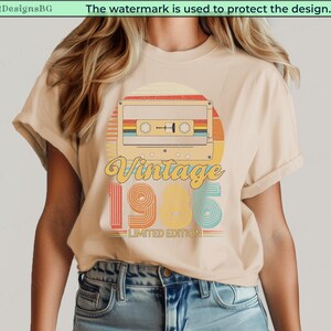 May include: Beige t-shirt with a retro design featuring a cassette tape, the word "Vintage," and the year "1985." The design includes colorful stripes and the text "Limited Edition."